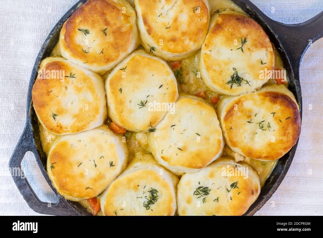 Top view of Chicken Pot Pie with biscuits used on top cooked to a toasty golden brown in a cast iron skillet. Stock Photo