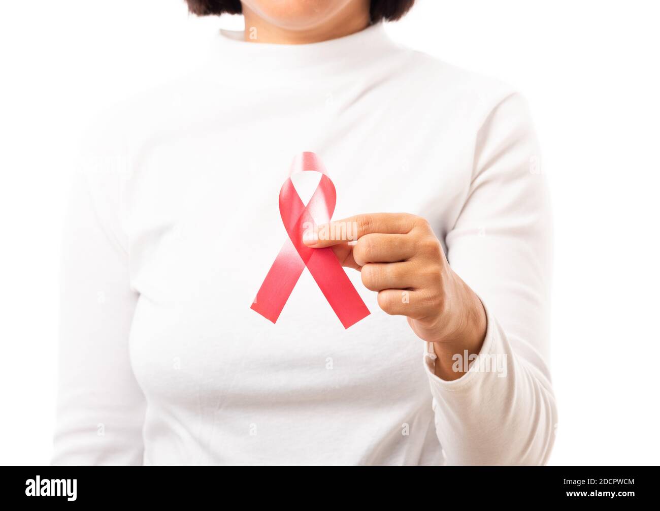 Female holding HIV AIDS awareness red ribbon on hands in studio shot ...