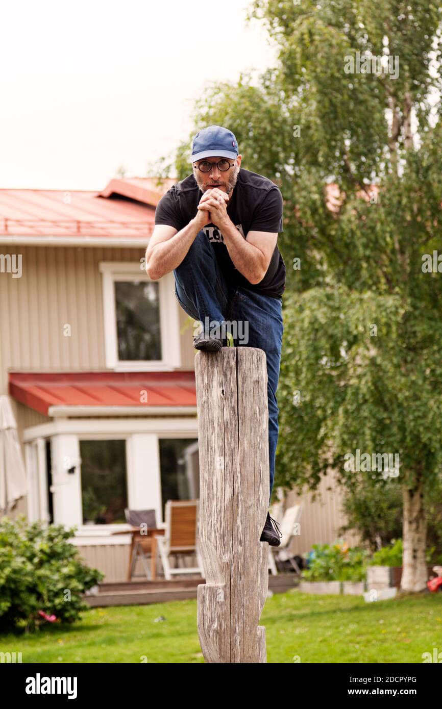 Umea, Norrland Sweden - August 4, 2020: a man is climbing a high pole and praying Stock Photo