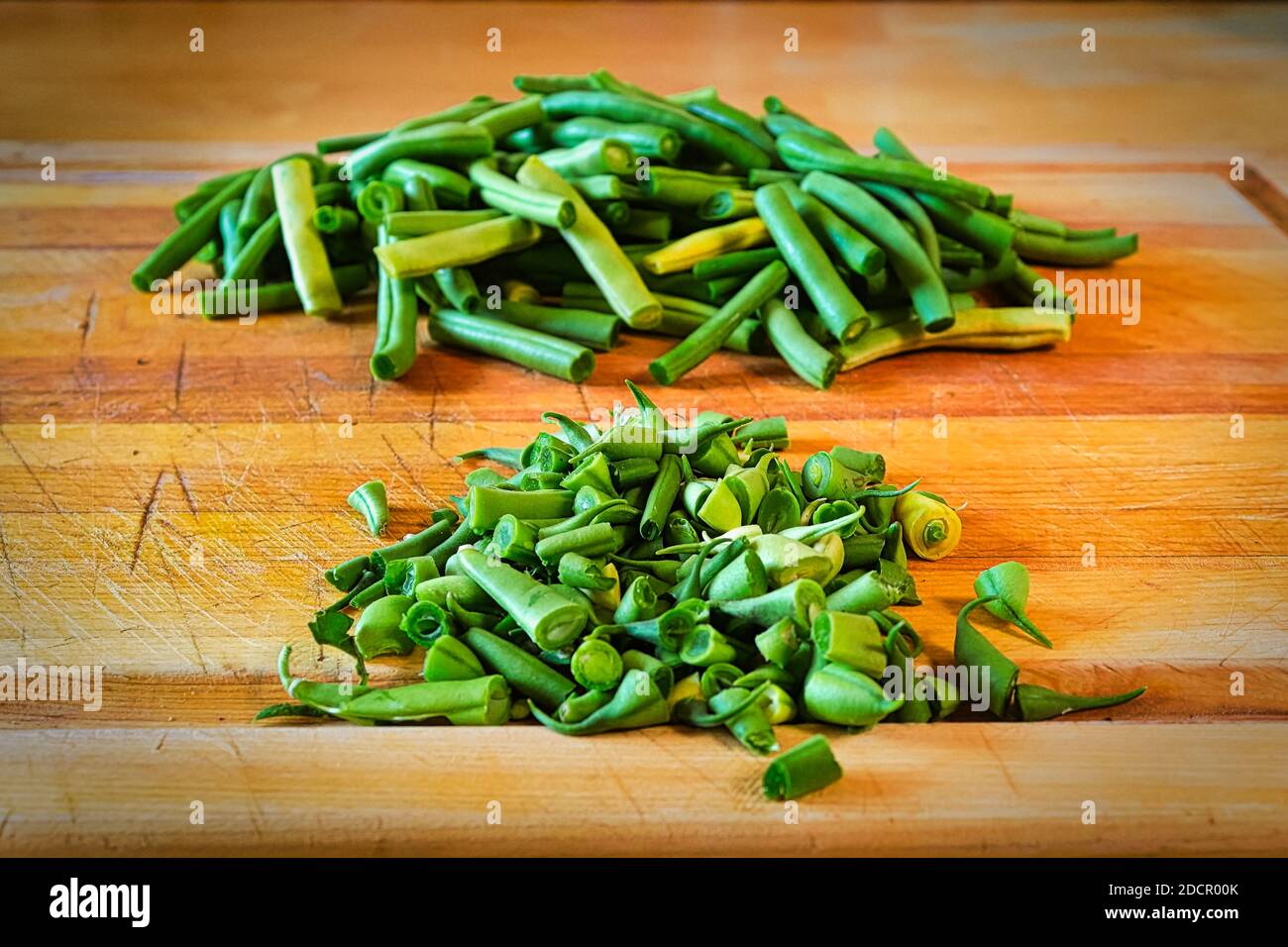 Green beans split into two piles, end cuts and edibles Stock Photo Alamy