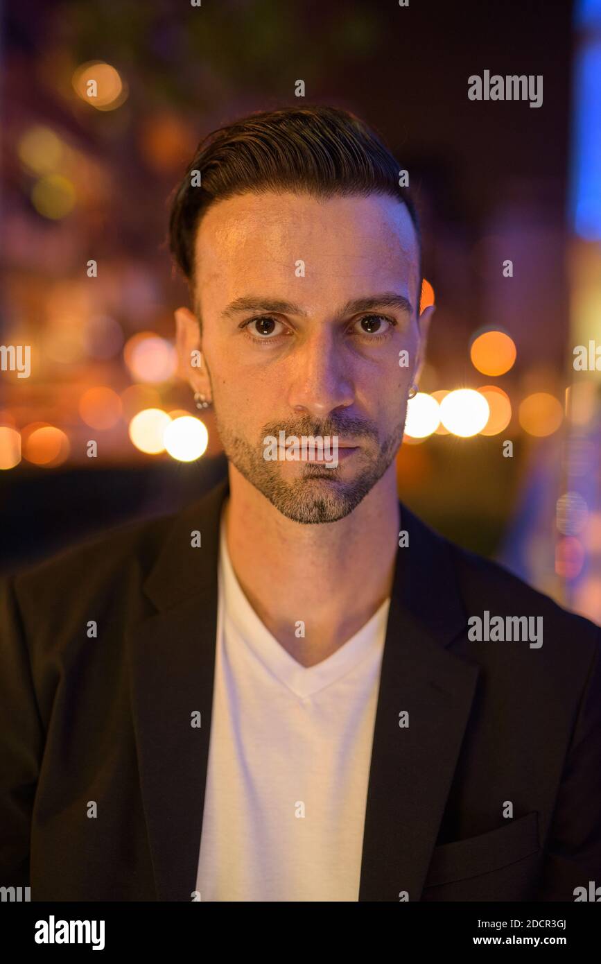 Portrait of young businessman against a city by night Stock Photo - Alamy