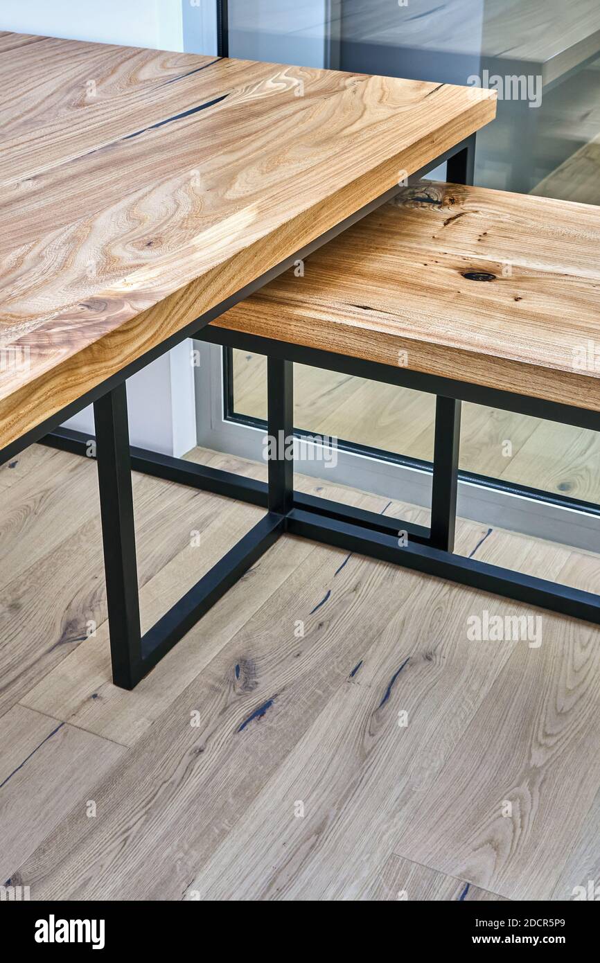 Live edge elm gaming desk countertop with metal base in a modern home office. Fragment of the desk Stock Photo