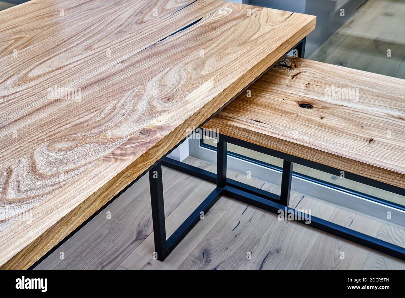 Live edge elm gaming desk countertop with metal base in a modern home office. Fragment of the desk Stock Photo