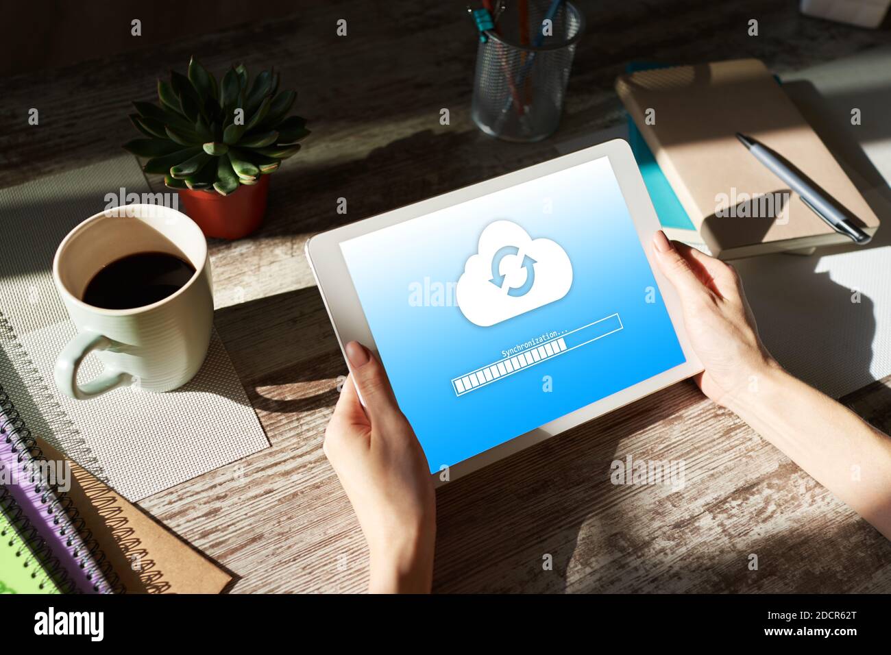 Cloud synchronization progress bar on tablet screen. Data storage and protection. Technology and internet concept Stock Photo