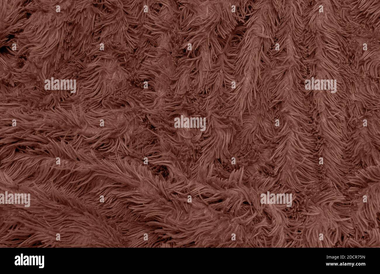 abstract background of detail bright pattern texture shaggy fur with long fibers. Polyester synthetic or natural fluffy plaid. Comfortable home textil Stock Photo