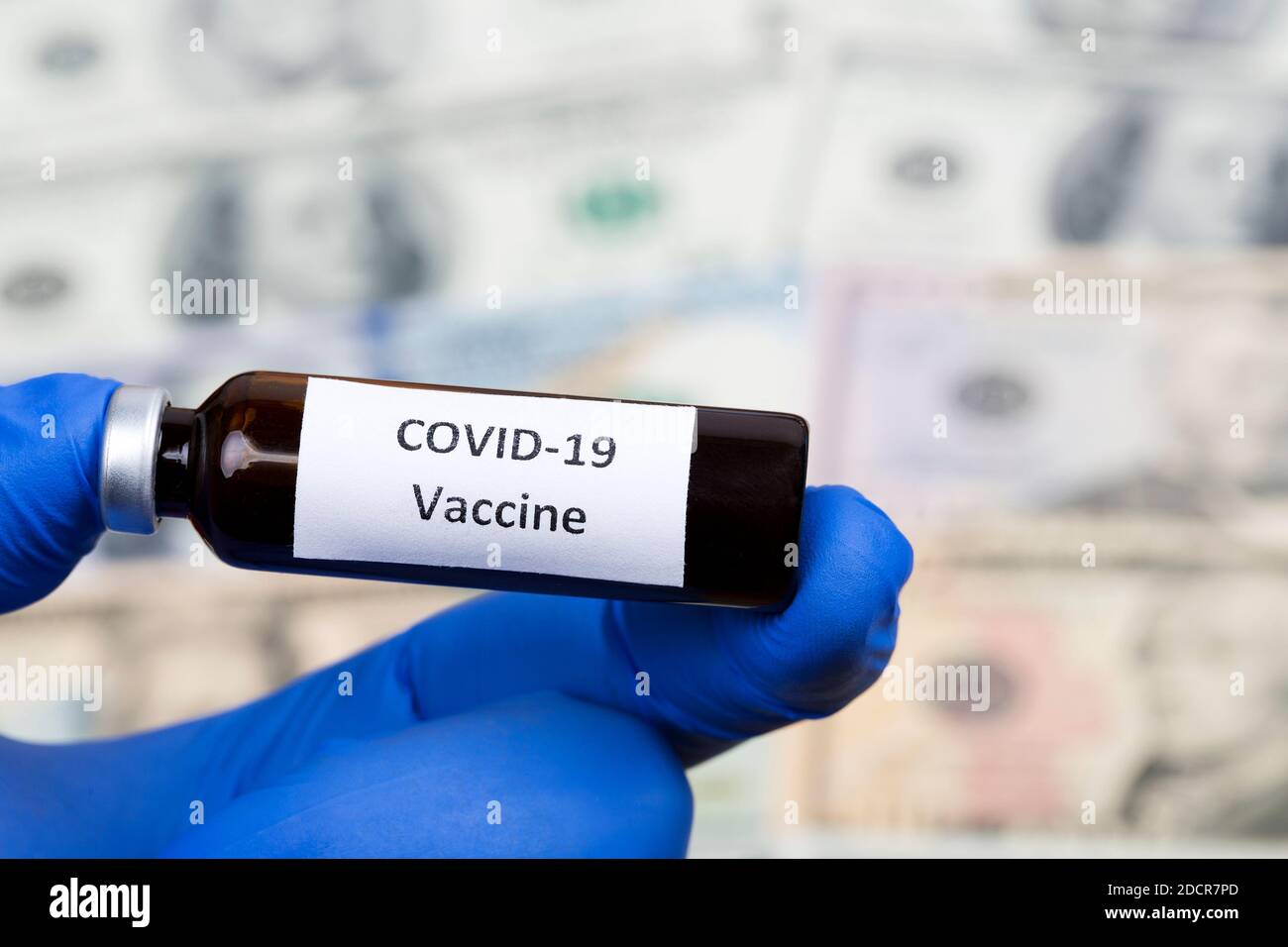 Vaccine against Covid-19 on the background of American Dollars Stock Photo