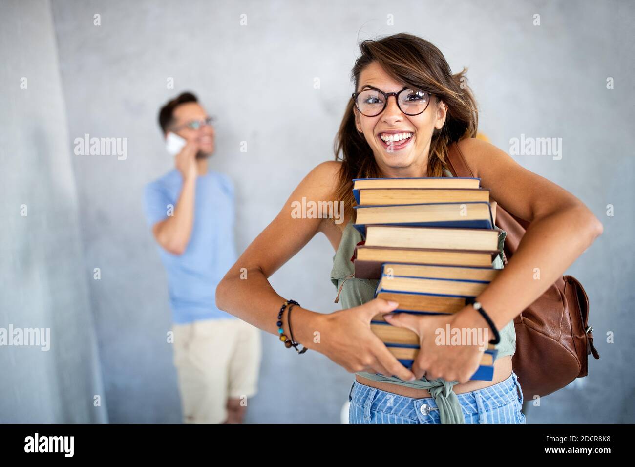 Stylish nerd girl with many books. Education, study, people, university concept. Stock Photo
