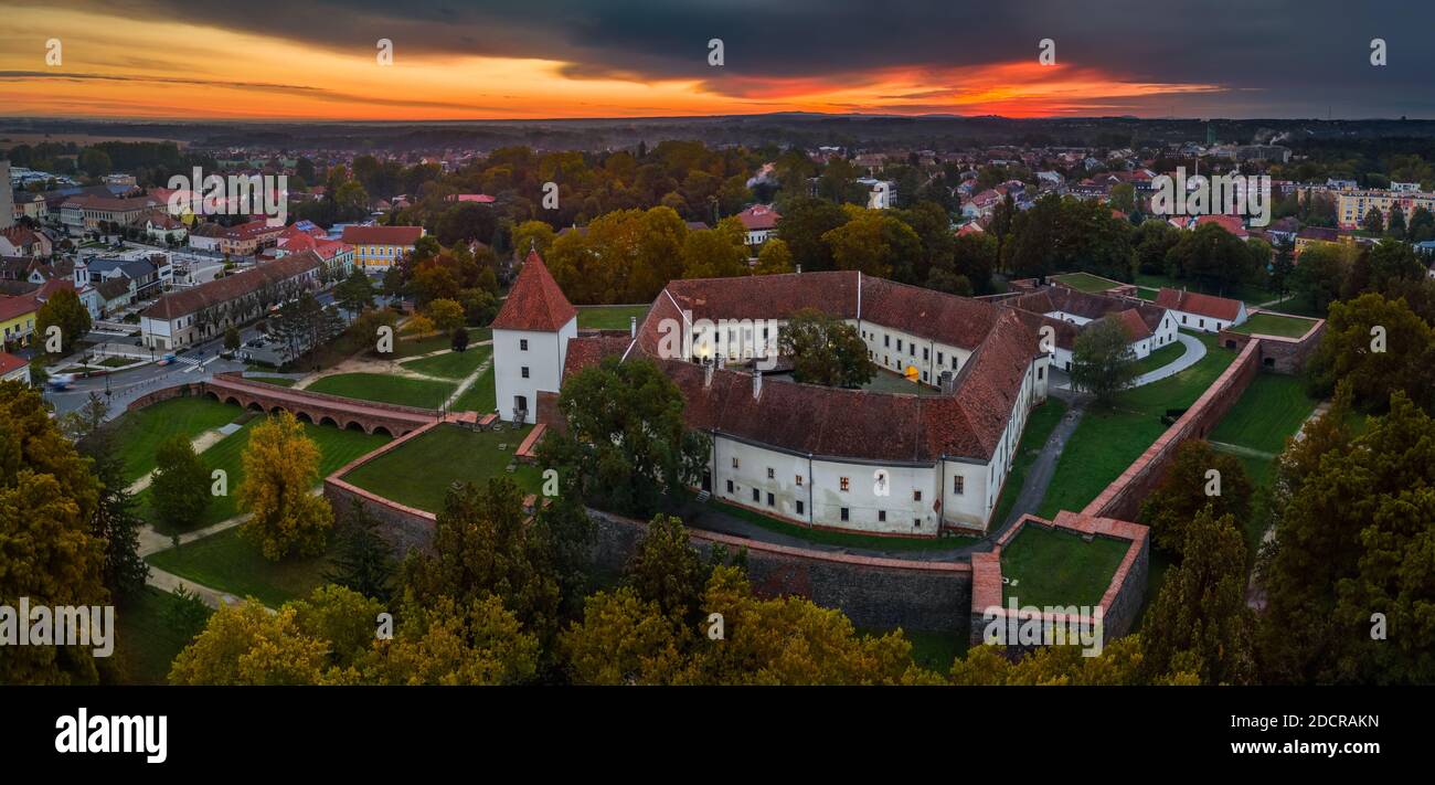 Sarvar, Hungary - Aerial panoramic view of the Castle of Sarvar (Nadasdy castle) with Sarvar Arboretum, a beautiful dramatic sunrise and rain clouds a Stock Photo