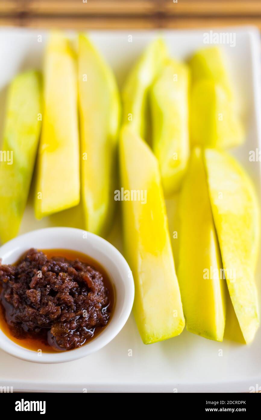 Sliced green mango with bagoong popular in the Philippines Stock Photo