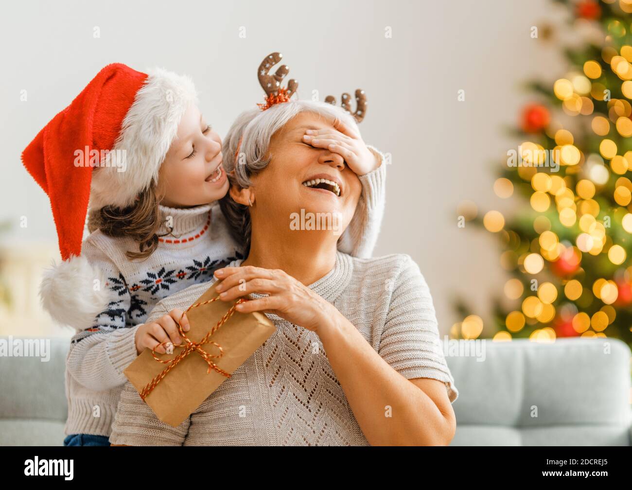 Excited Grandmother Receiving Christmas Gift From Granddaughter At Home  Stock Photo - Alamy