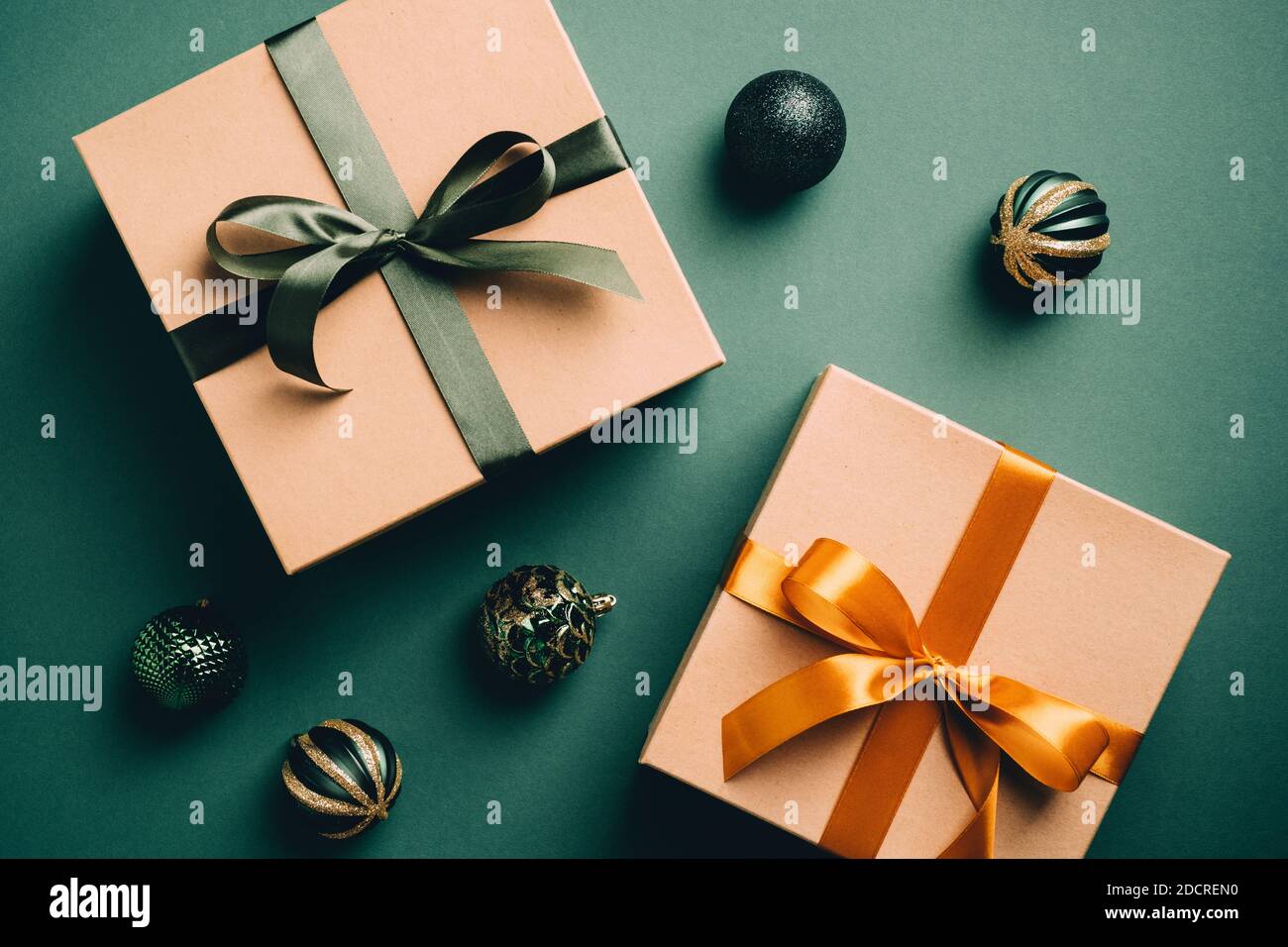 Vintage Christmas composition with carton gift boxes and balls on dark  green background. Retro style. Flat lay Stock Photo - Alamy