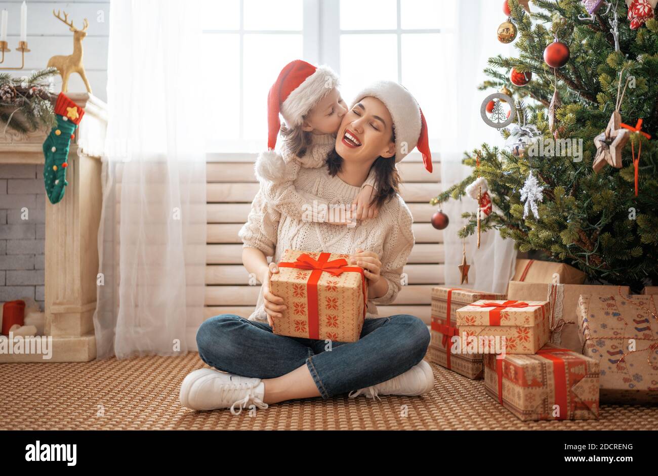Father and adult daughter exchanging Christmas gifts Stock Photo by  ©photography33 7910626