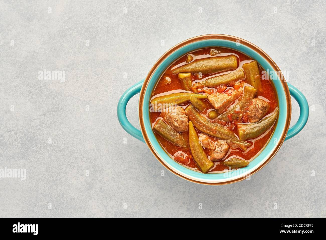 Homemade okra and meat stew in a pot. Top view, copy space Stock Photo