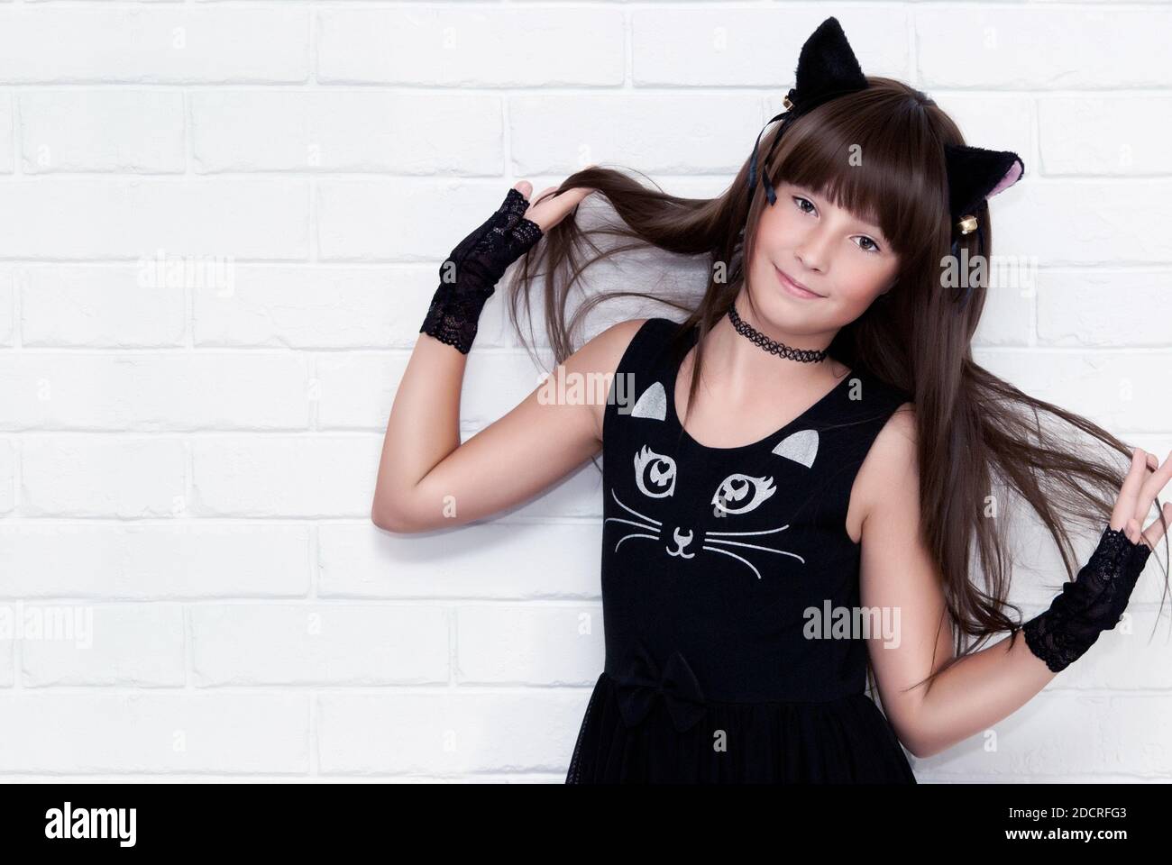 Portrait of cute teen girl disguised as a kitten. Stock Photo