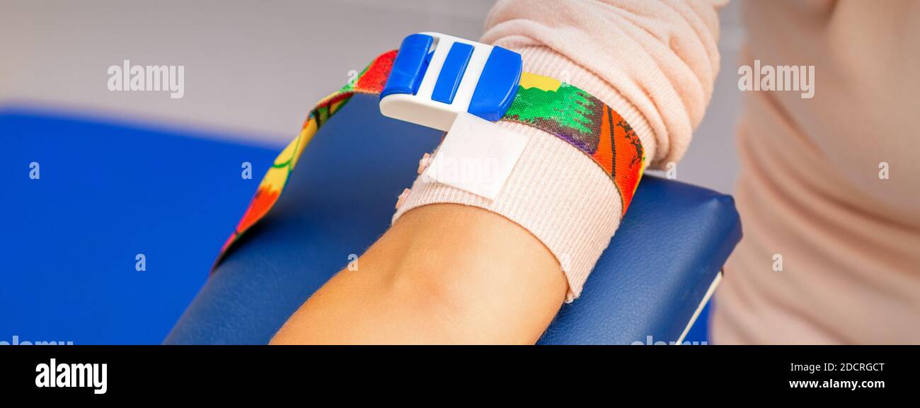 Medical tourniquet on the hand of female patient in the hospital Stock