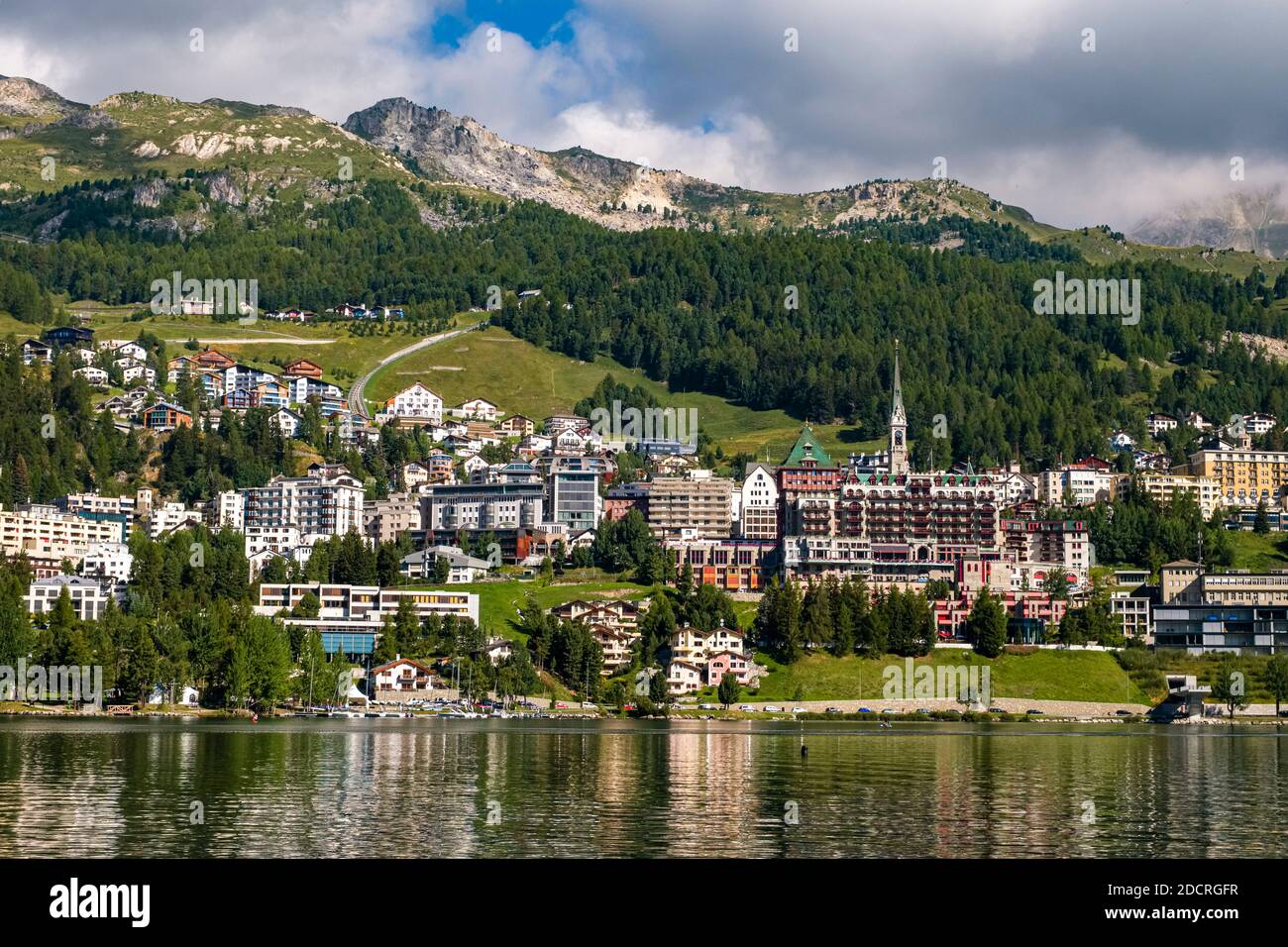 The town of St. Moritz is located at the shore of Lake St. Moritz, the southern slopes of the Albula Alps in the distance. Stock Photo