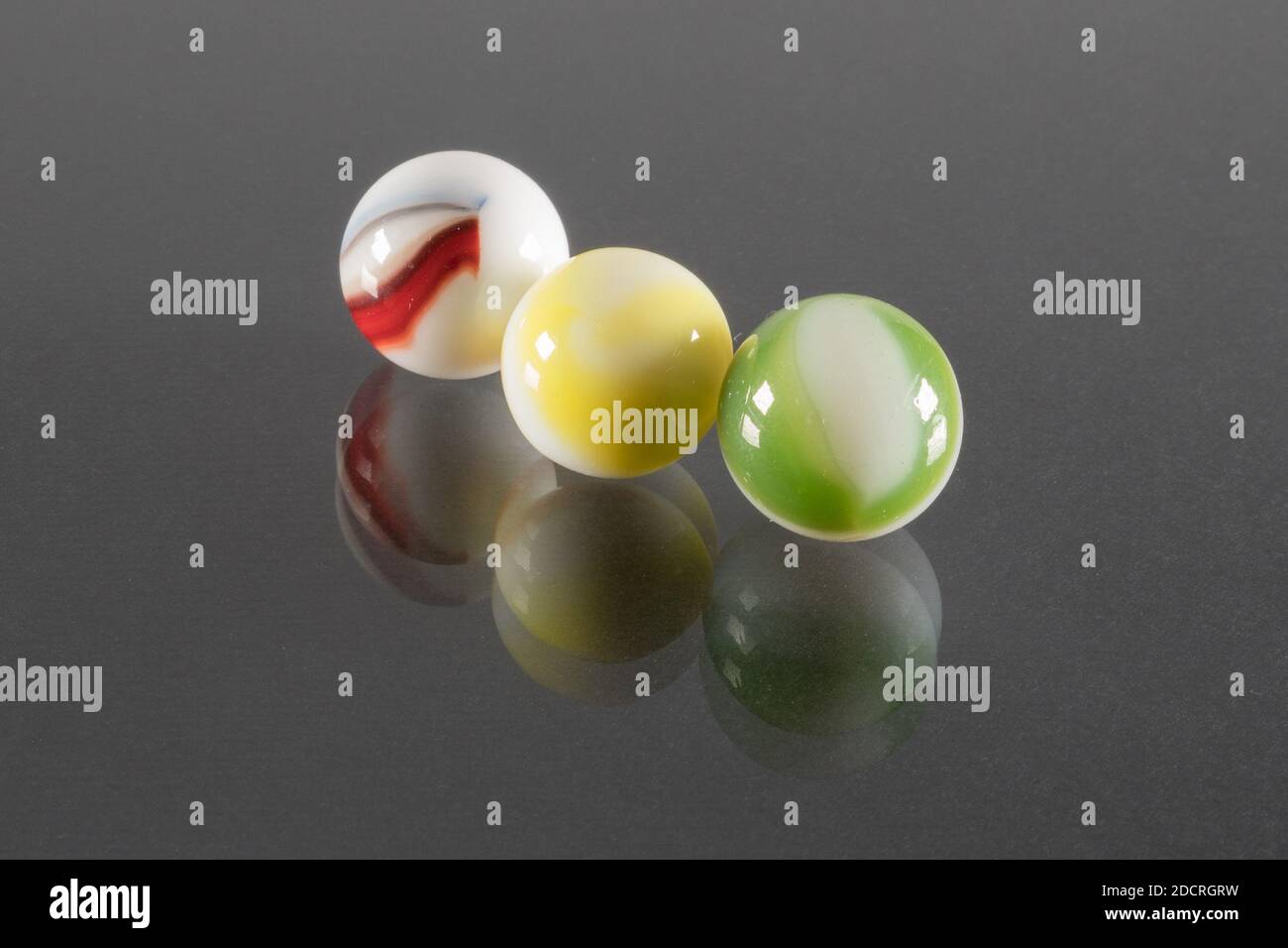 Three Small White Ceramic Balls with Veins and Black Background. Stock Photo