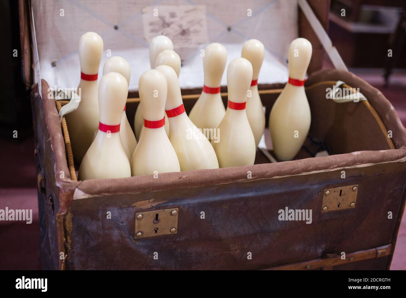 Set of White Bowling Pins inside an open Casket. Stock Photo