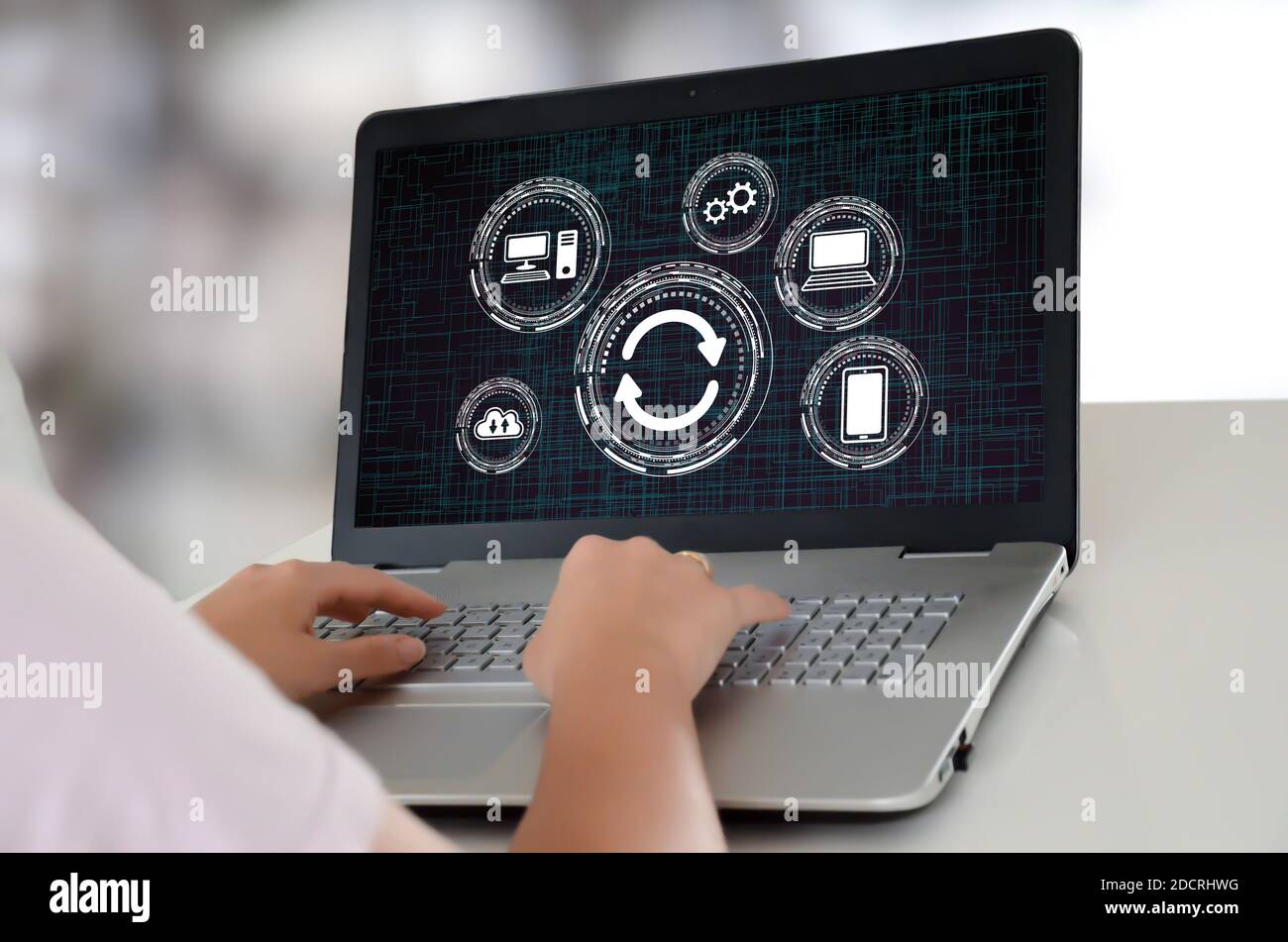 Woman using a laptop with system update concept on the screen Stock Photo