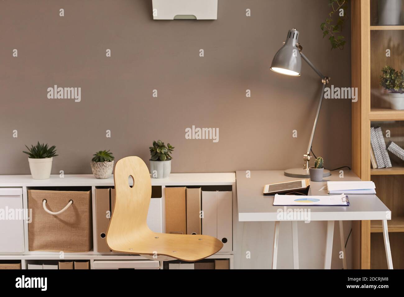 Minimal background image of cozy workplace lit by warm lighting from metal  desk lamp, copy space Stock Photo - Alamy