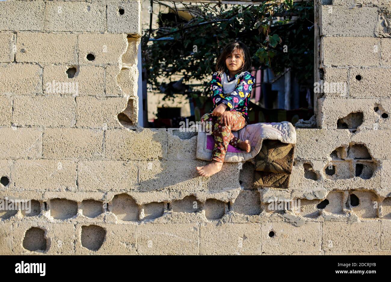 Gaza, Palestine. 22nd Nov, 2020. A Palestinian girl sits at the window ...
