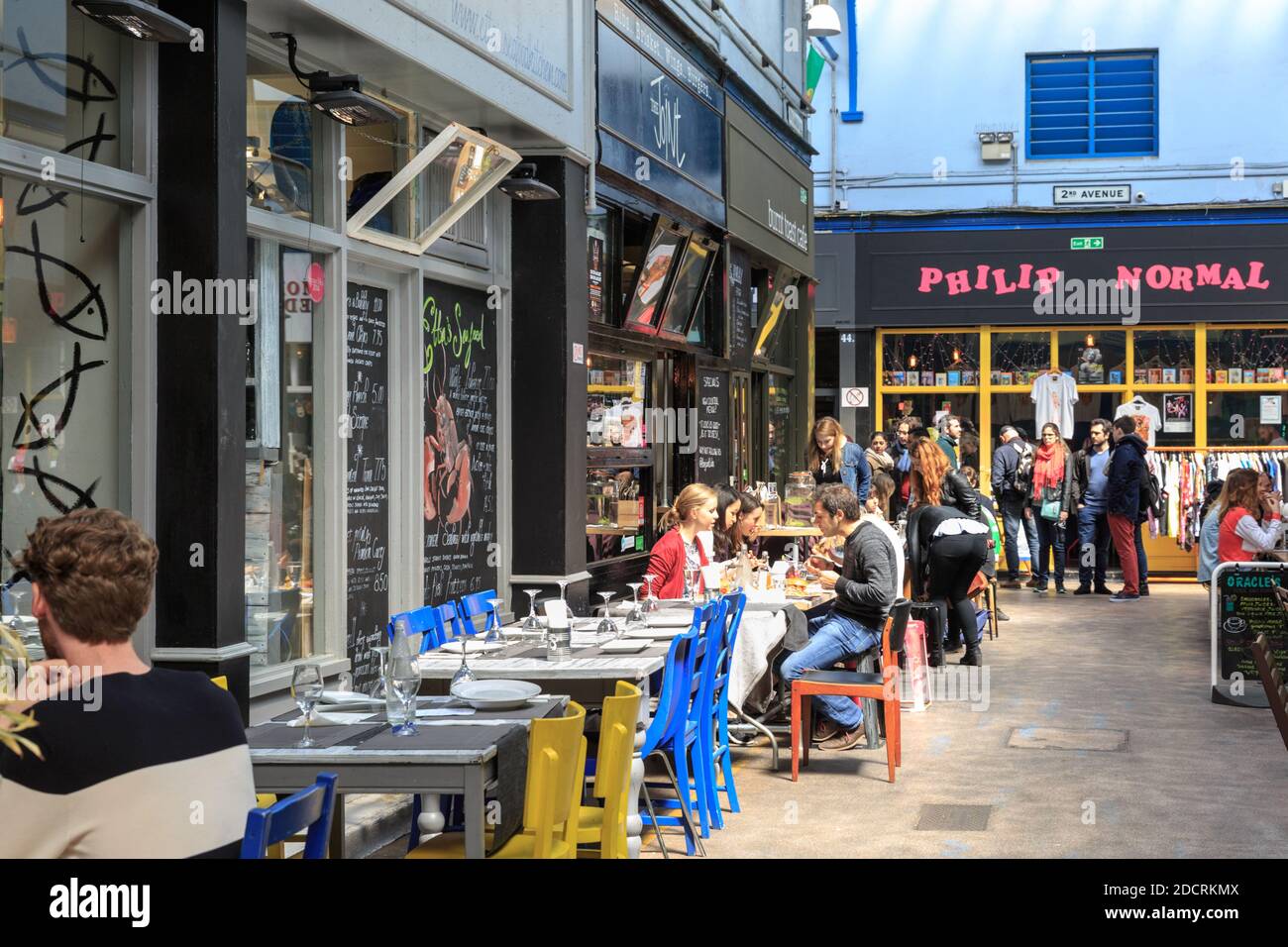 People browse, eat and drink in Brixton Village Market, Brixton, London