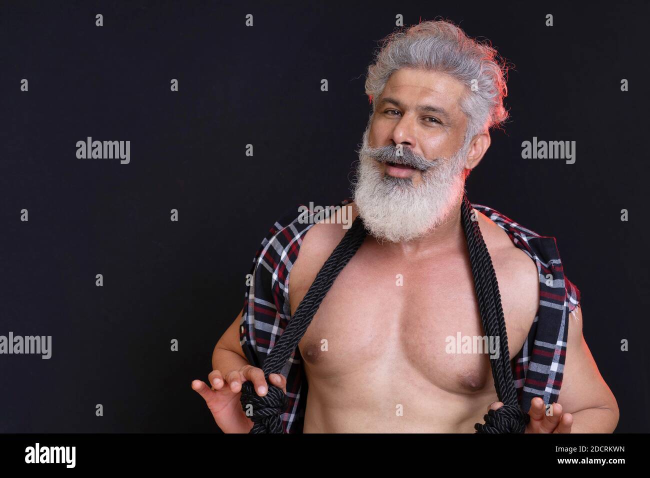 Man with long white beard, muscular body. Looking at camera. Black  background Stock Photo - Alamy