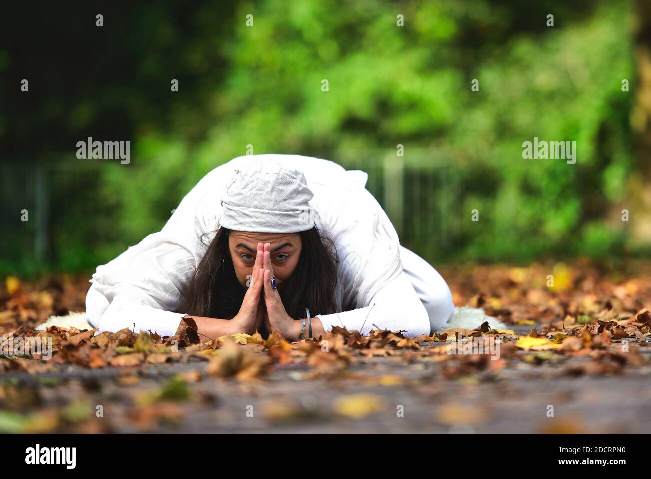 Yoga position among the autumn leaves in the park Stock Photo