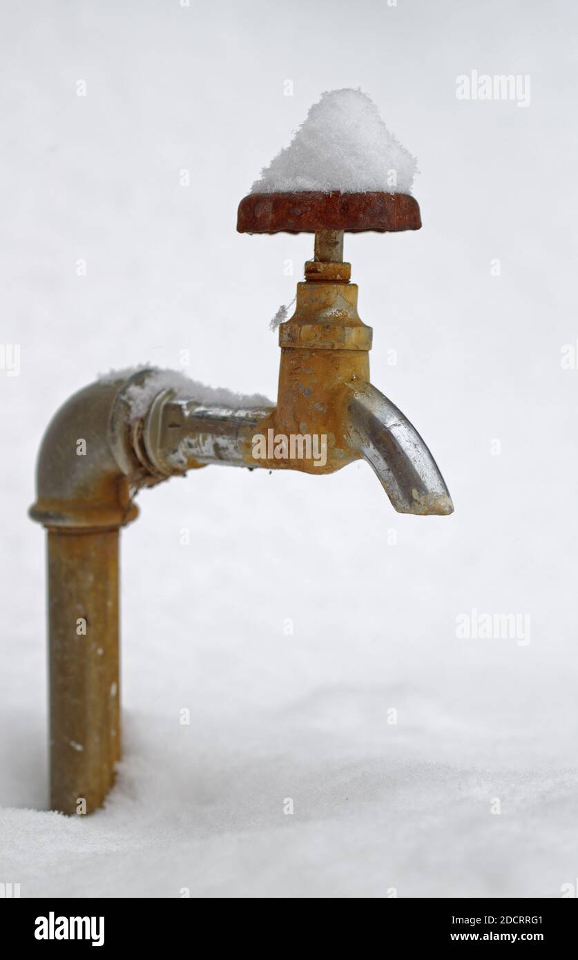 Close up a faucet covered with snow. Stock Photo