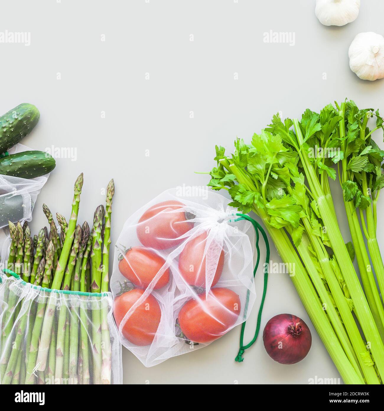 Fresh organic vegetables in eco reusable produce shopping bags flat lay ...