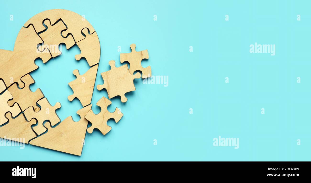 Heart made of puzzle pieces, with a hole as a symbol of the disease. Stock Photo