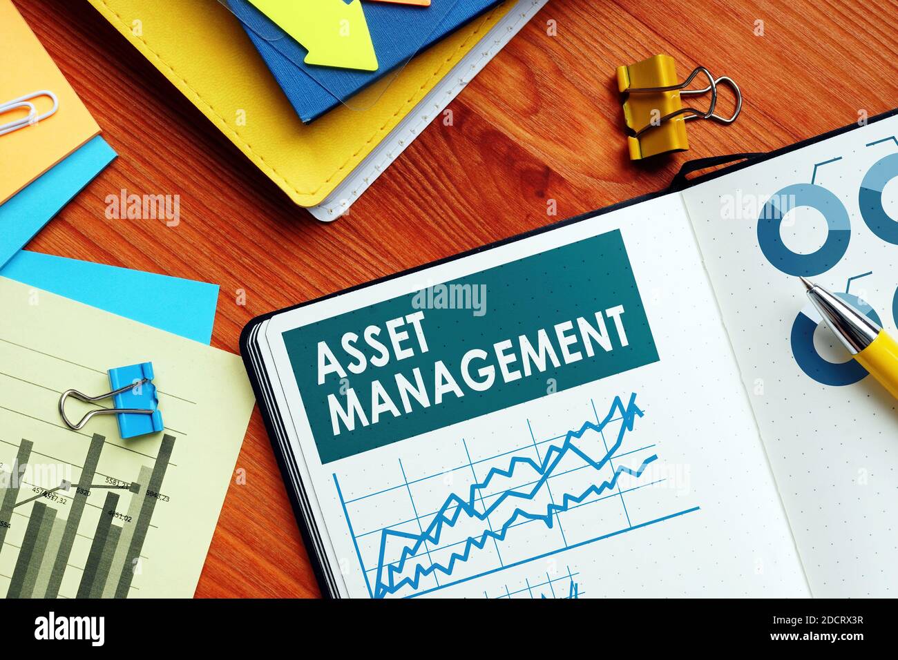 Asset Management papers with charts and graphs. Stock Photo