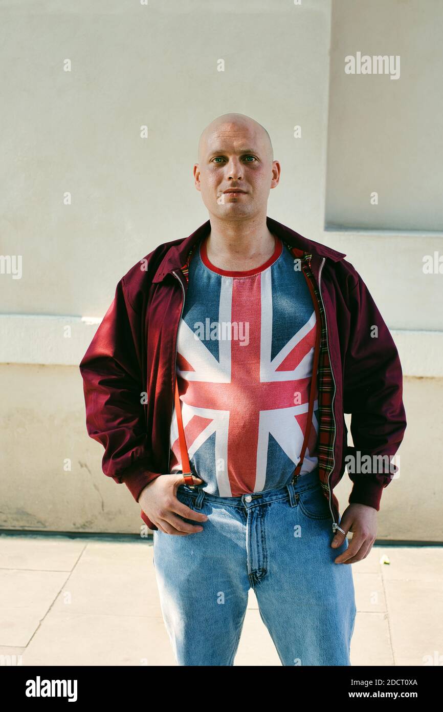 Skinhead wearing Union Jack t-shirt protesting for Brexit in front of Parliament in Westminster, London UK Stock Photo