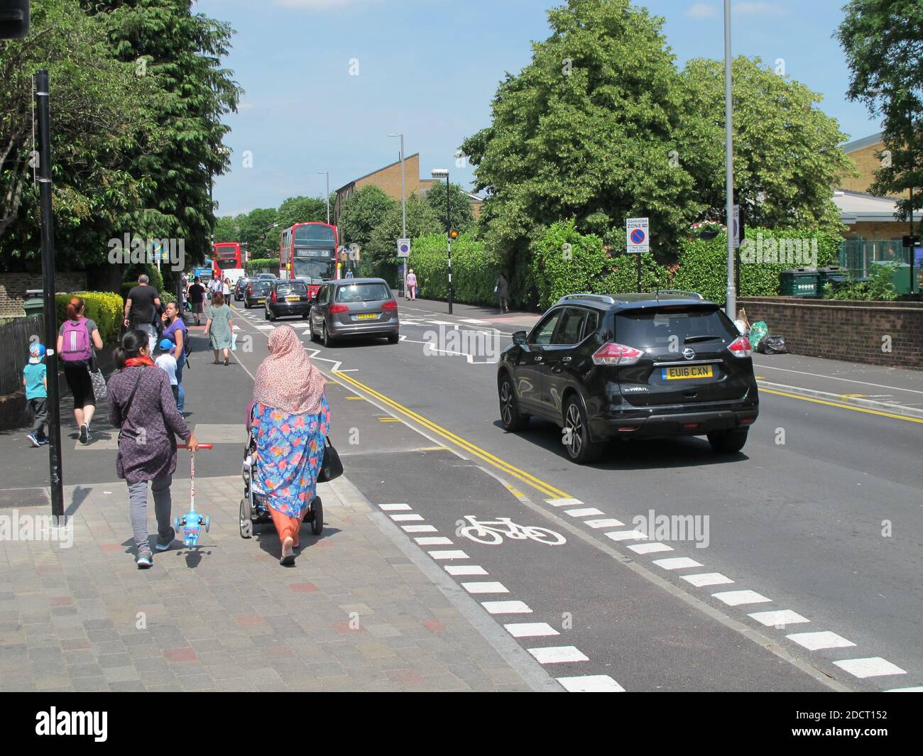 A family crosses a newly remodelled junction on Markhouse Road, London, UK. Part of Waltham Forest's Mini Holland scheme for safer streets Stock Photo