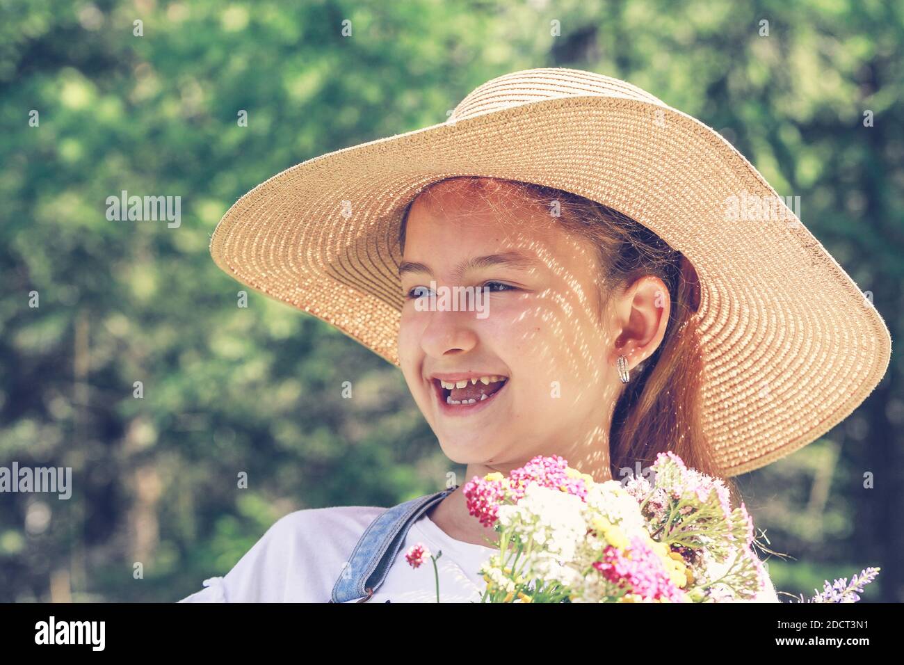 Cute attractive caucasian girl in a straw hat on a summer background. Summer portrait Stock Photo