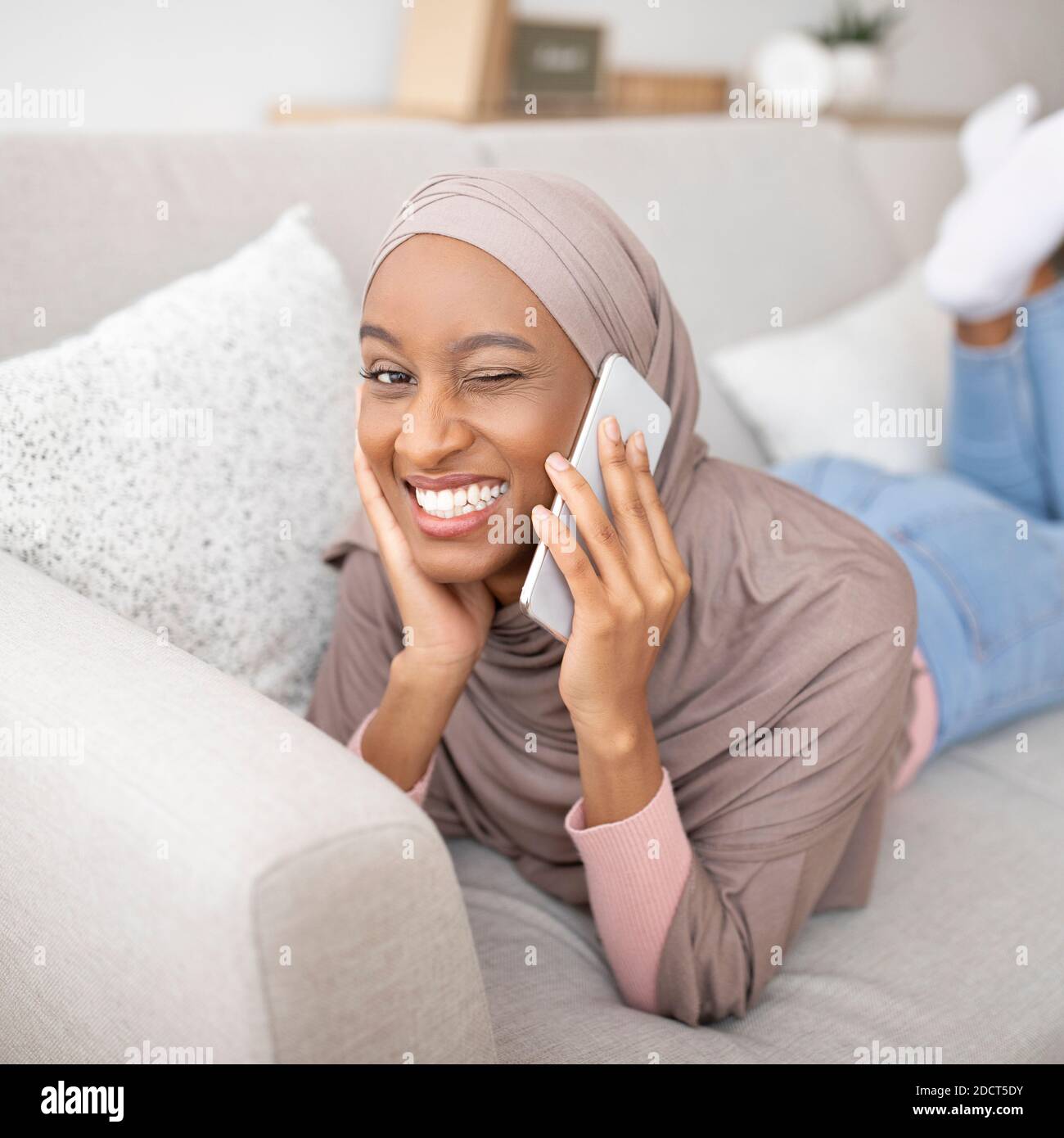 Gorgeous black woman in hijab talking on mobile phone and winking her ...