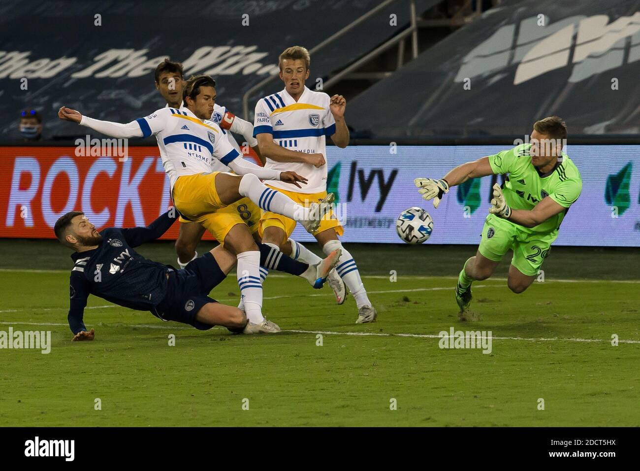 Kansas City, Kansas, USA. 21st Nov, 2020. At forefront (r-l), Sporting KC goalkeeper Tim Melia #29 dives against the offense of San Jose Earthquakes forward Cade Cowell #44 during playoff overtime. Behind (l-r) are Sporting KC midfielder Ilie Sanchez #6, San Jose Earthquakes forward Chris Wondolowski #8 and San Jose Earthquakes midfielder Jackson Yueill #14. Credit: Serena S.Y. Hsu/ZUMA Wire/Alamy Live News Stock Photo