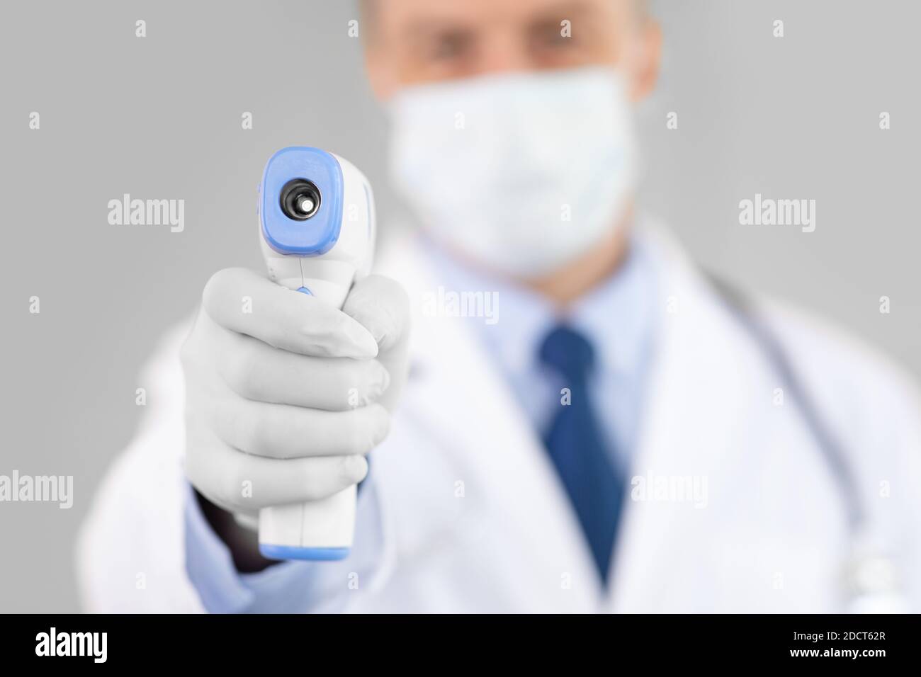 Doctor checking temperature using infrared thermometer gun Stock Photo