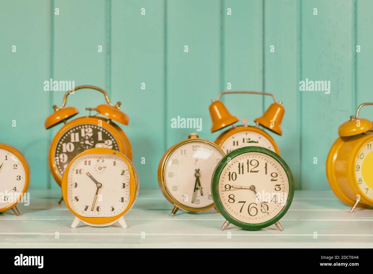 Retro styeled image of a set of different colorful alarm clocks Stock Photo