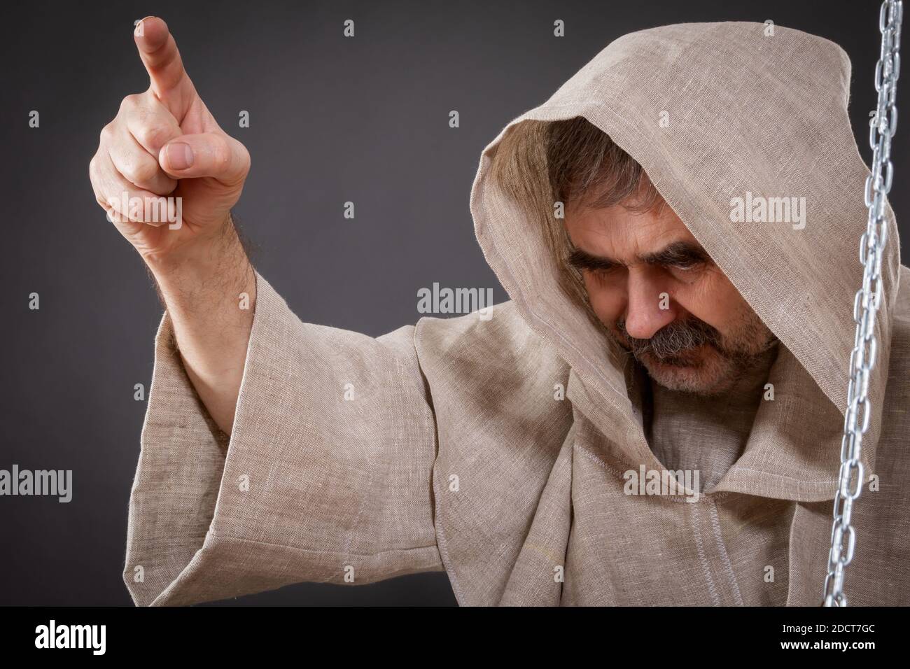 Halloween concept. The judge of the holy inquisition pronounces judgment on the sinner Stock Photo