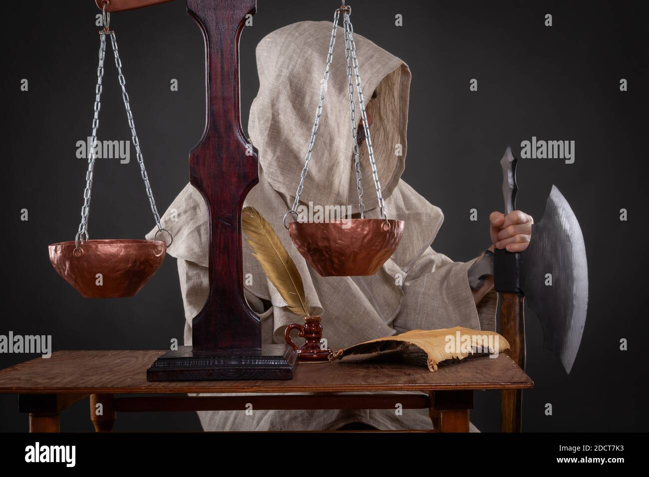 Halloween concept. The executioner of the holy inquisition with an ax weighing other people's sins Stock Photo
