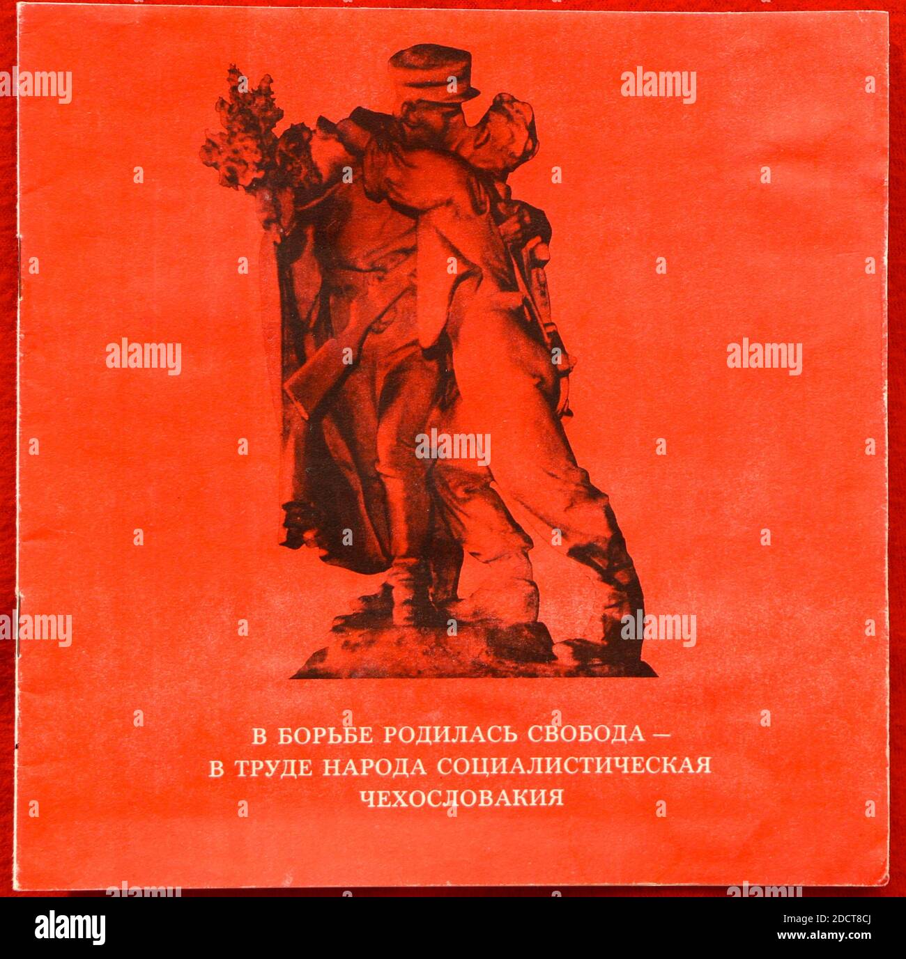Photo of a Russian language propaganda booklet in red and black given to students in Soviet Russia in 1976 with a couple embracing and kissing Stock Photo