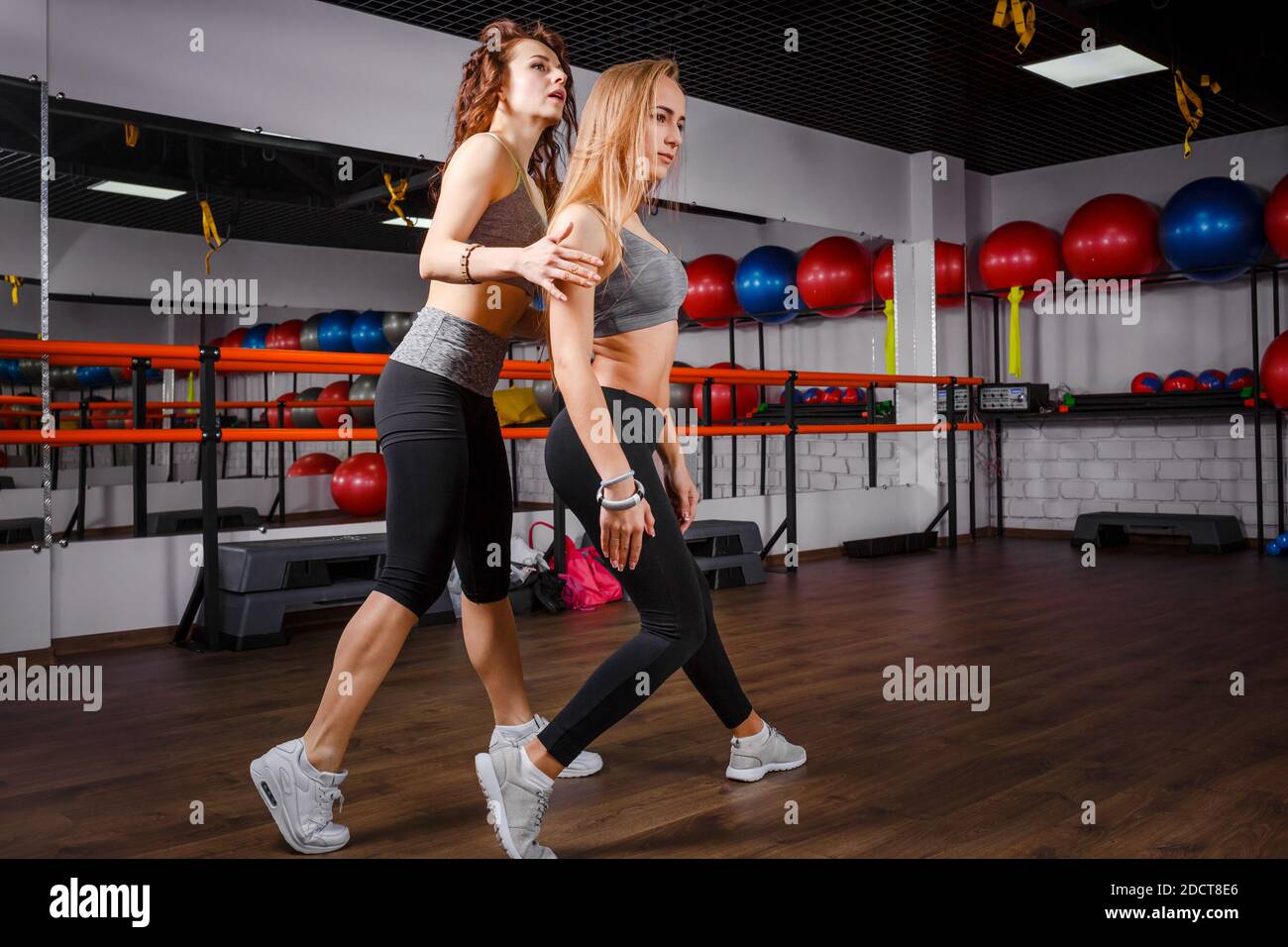 Young sporty girl with her dance teacher in studio Stock Photo