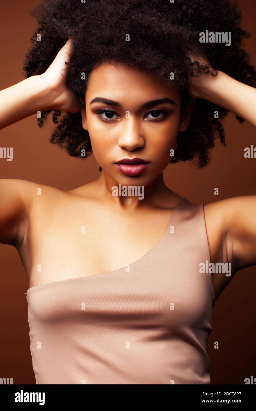pretty young african american woman with curly hair posing cheerful ...