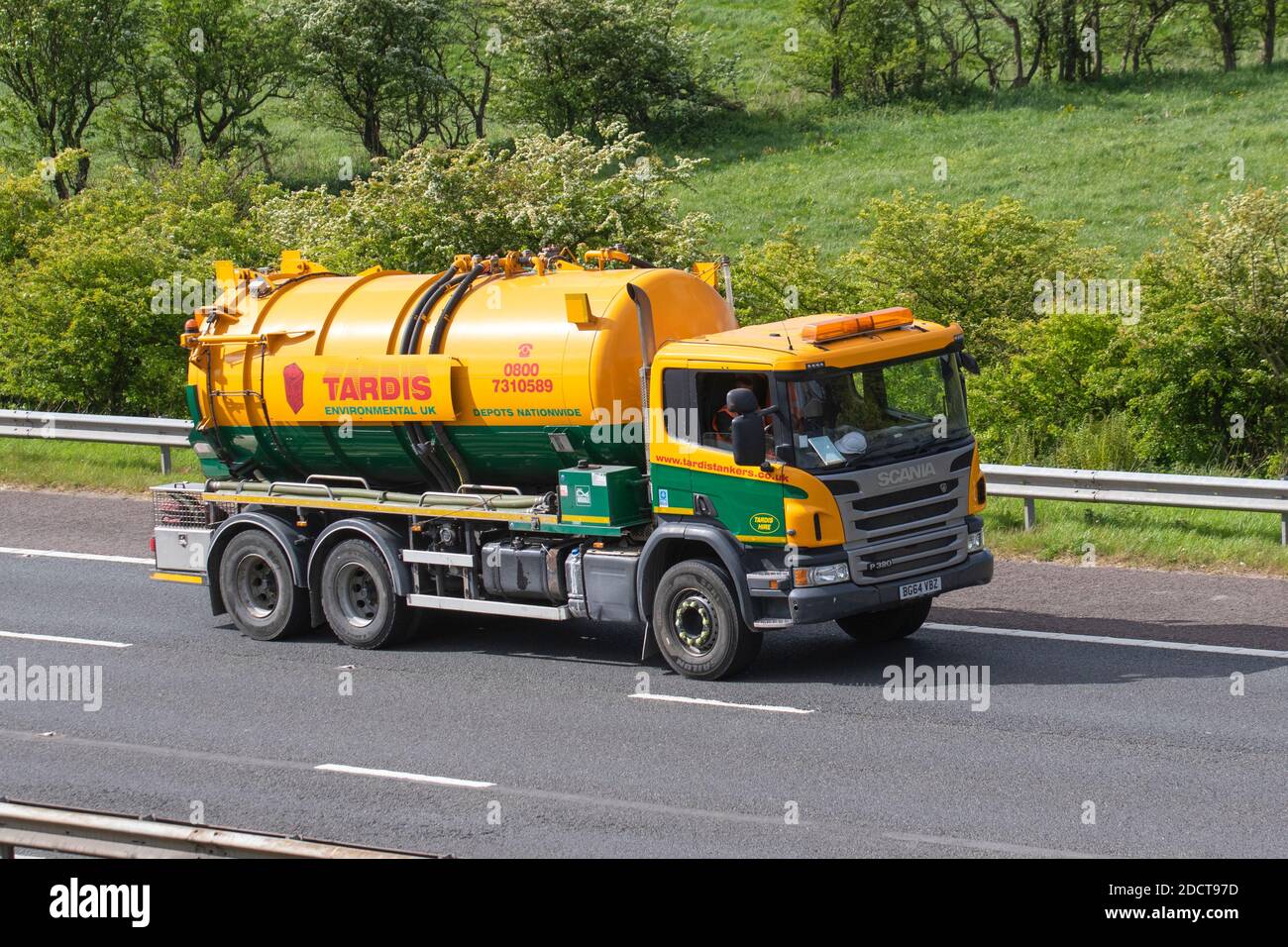 Tardis Tankers green yellow; Haulage delivery trucks, lorry, transportation, truck, cargo carrier, Scania vehicle, European commercial transport, industry, M61 at Manchester, UK Stock Photo