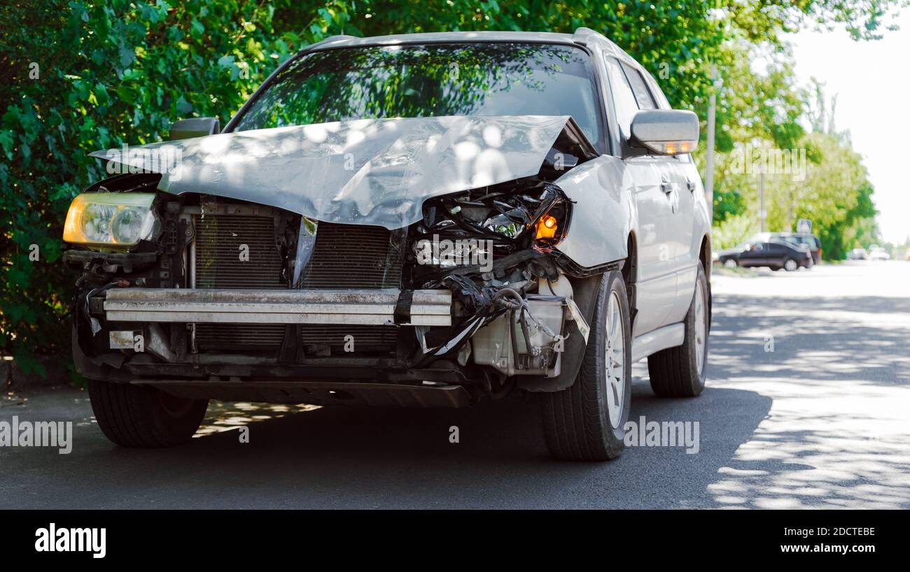 Destroyed car in car crash traffic accident on city road. Smashed