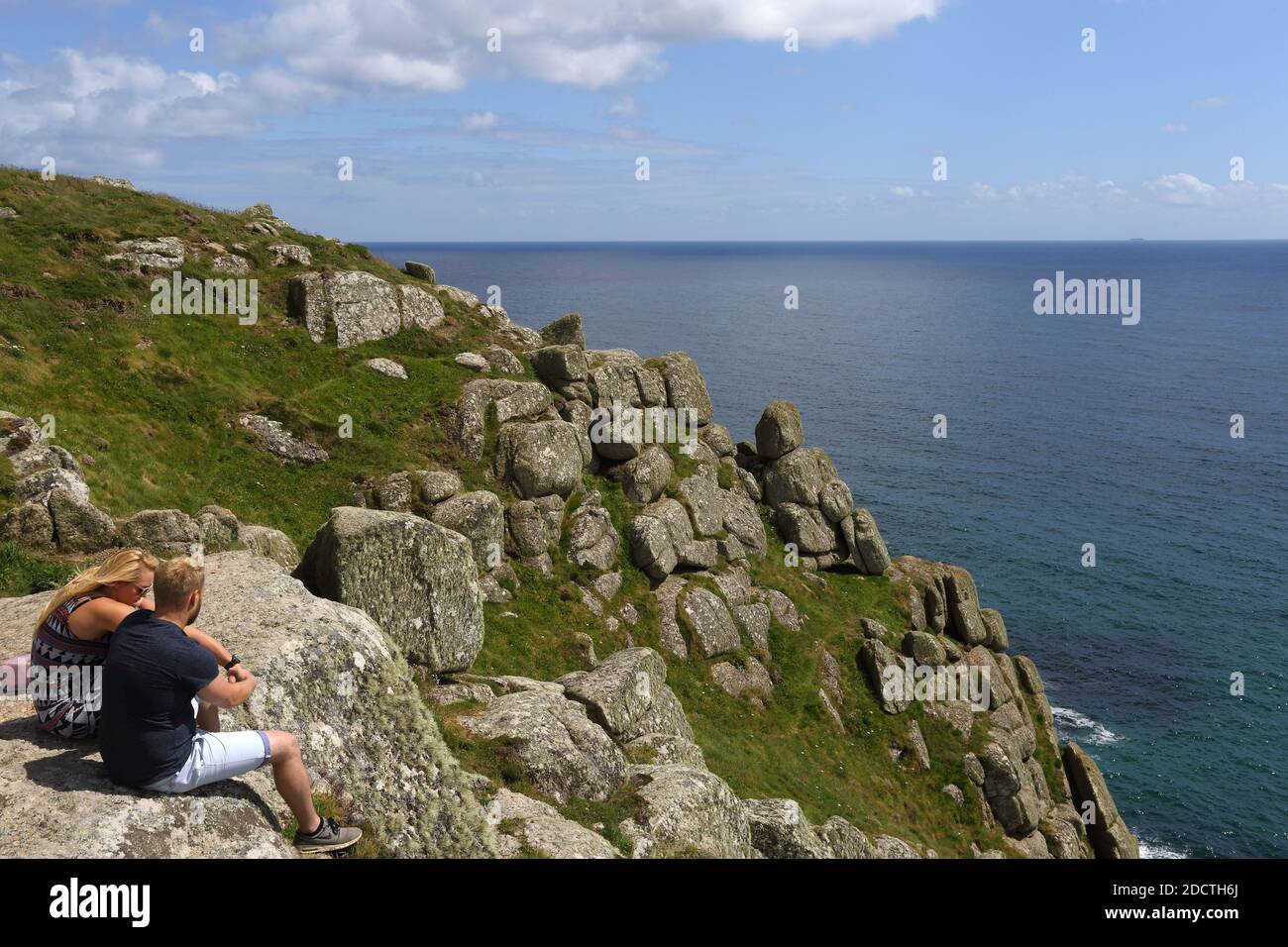 Coupel looking over Porthcurno coastline and cliffs, Cornwall, England, Stock Photo