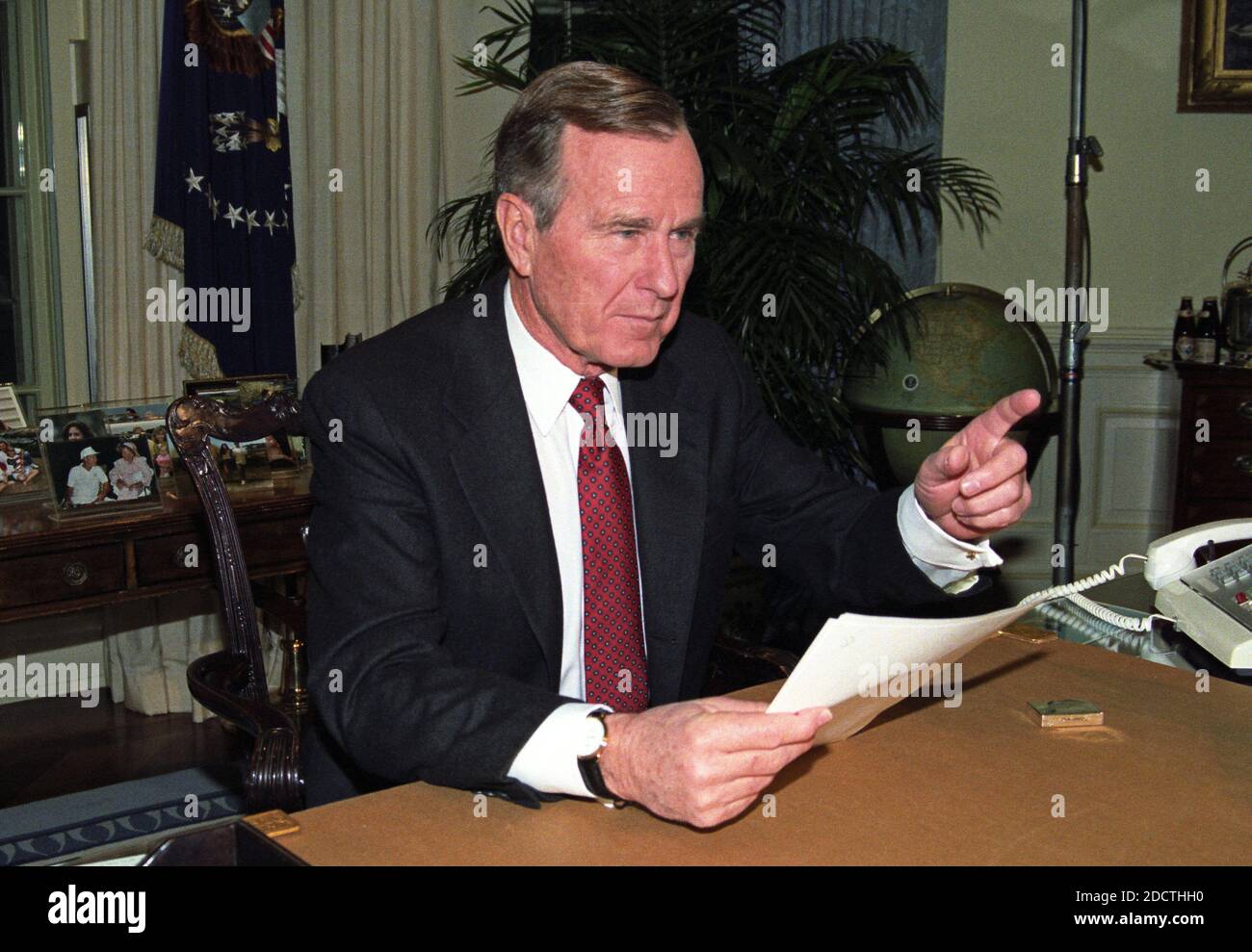 United States President George H.W. Bush poses for photographers after delivering an address to the nation from the Oval Office of the White House in Washington, DC on Christmas Day, December 25, 1991 announcing the resignation of President Mikhail Gorbachev as President of the Union of Soviet Socialist Republics, marking the collapse of the Soviet Union and the end of the Cold War. Photo by Arnie Sachs / CNP /ABACAPRESSC.OM Stock Photo
