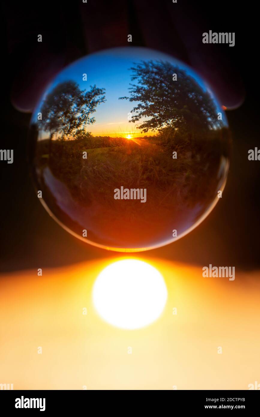Rural landscape with trees at sunset seen through a crystal ball Stock ...