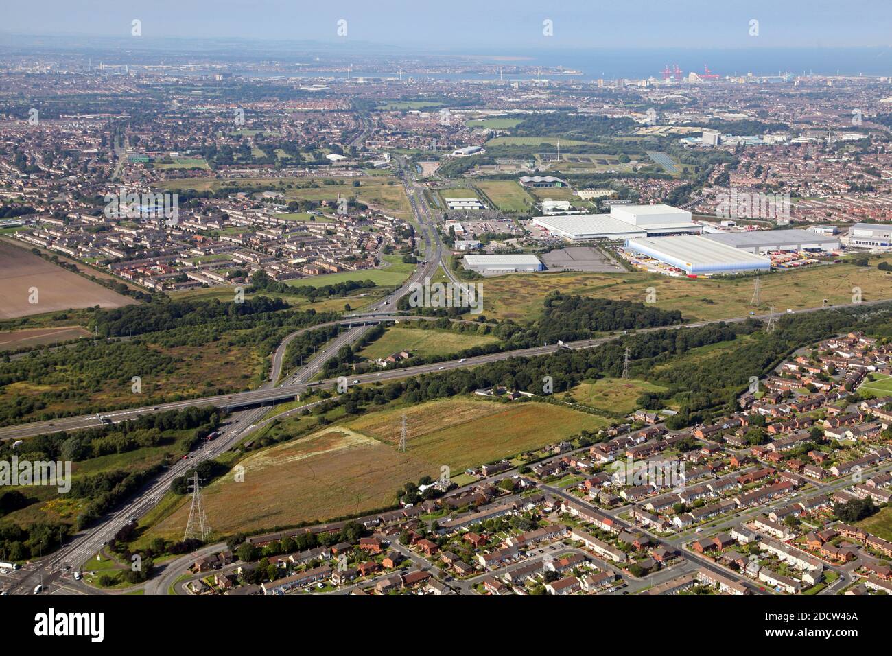 aerial view looking west along the East Lancs Road as it crosses the M57 motorway near Knowsley & Kirkby, Liverpool. Stock Photo